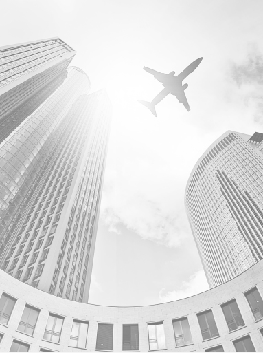 View from the ground of an Airplane flying over high rise buildings.