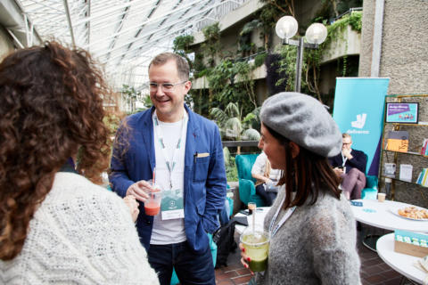 A man and two women at Leading design London in the Barbican conservatory