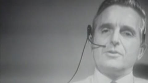 A screenshot from The Mother Of All Demos showing Douglas Engelbart wearing a headset.