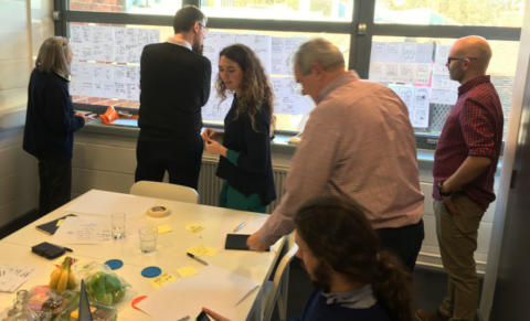 A group of people reviewing different design ideas