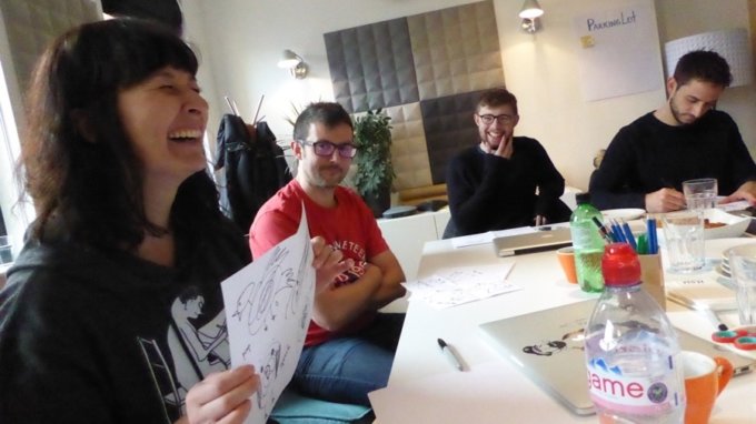 People gathered around a table, laughing.