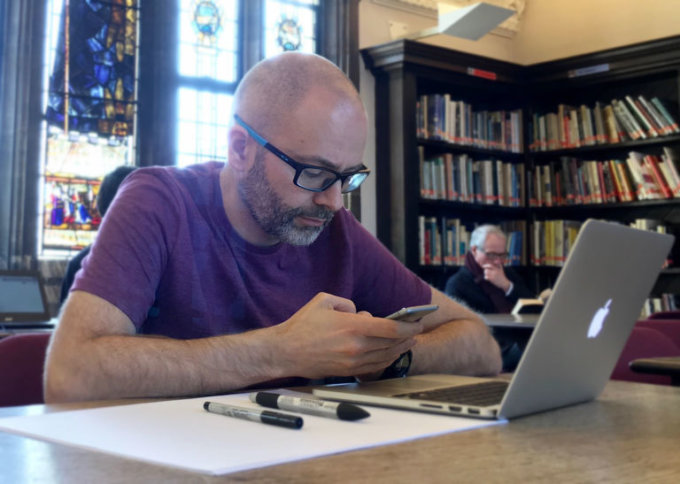 A man designing interfaces in Sketch in Suffolk library
