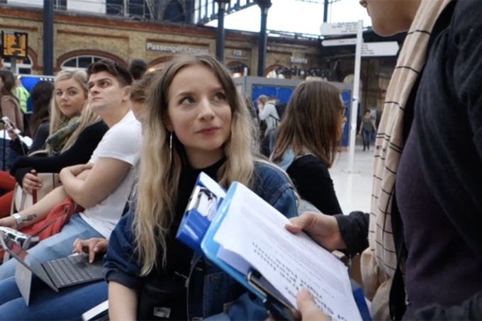 A commuter in a railway station being asked to participate.