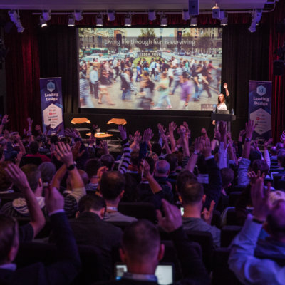 The audience raising their hands.