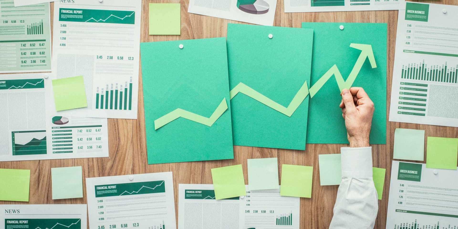 A table filled with financial forecast papers. 