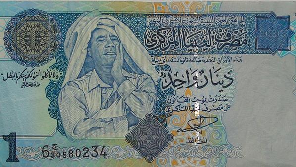 الدينار القديم به صورة للقذافي