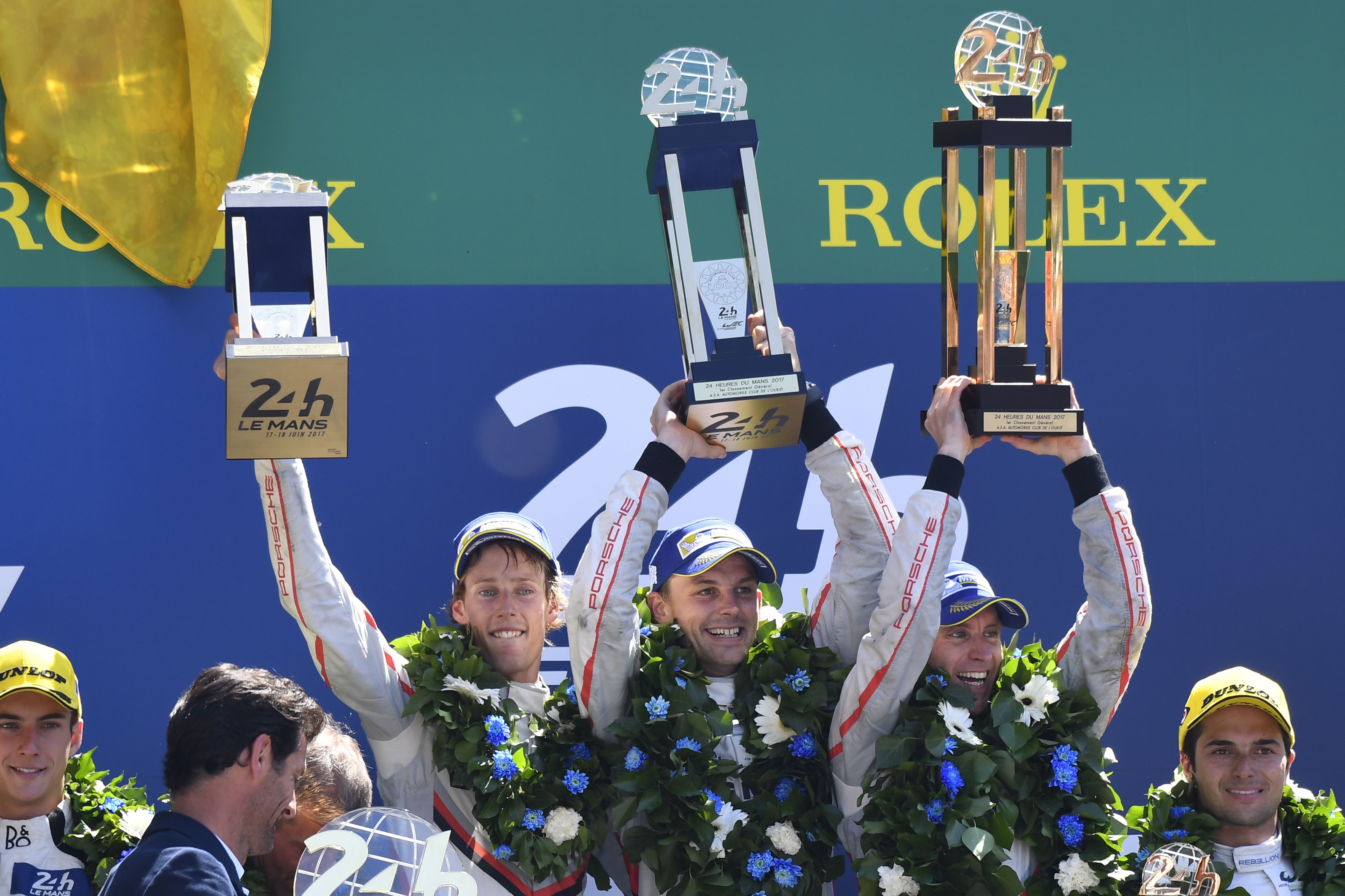Timo Bernhard, Earl Bamber and Brendon Hartley celebrate after claiming victory at Le Mans 