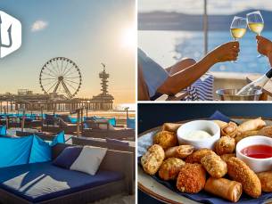 Luxe strandbed + fles wijn + bittergarnituur op het strand van Scheveningen