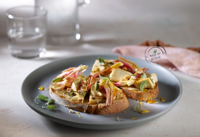 Bruschetta con ricotta al forno, carciofi, miele e nocciole