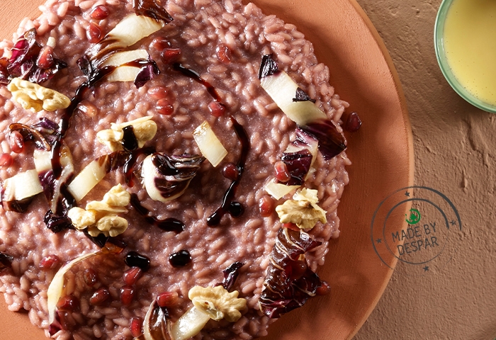Risotto alla melagrana, radicchio e noci mantecato all'olio di vinacciolo e balsamico
