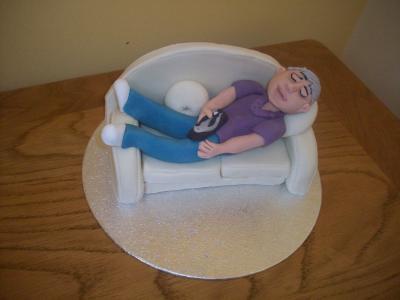 Man relaxing with TV Remote Cake Topper