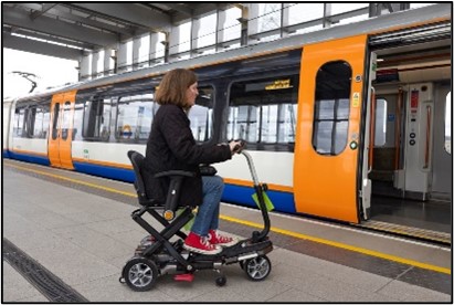 Woman on mobility scooter boarding WLO train