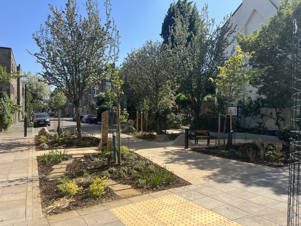 A photograph showing the new layout at the junction of Annette Road and Roden Street showing new planting beds, re-laid paving and new trees.