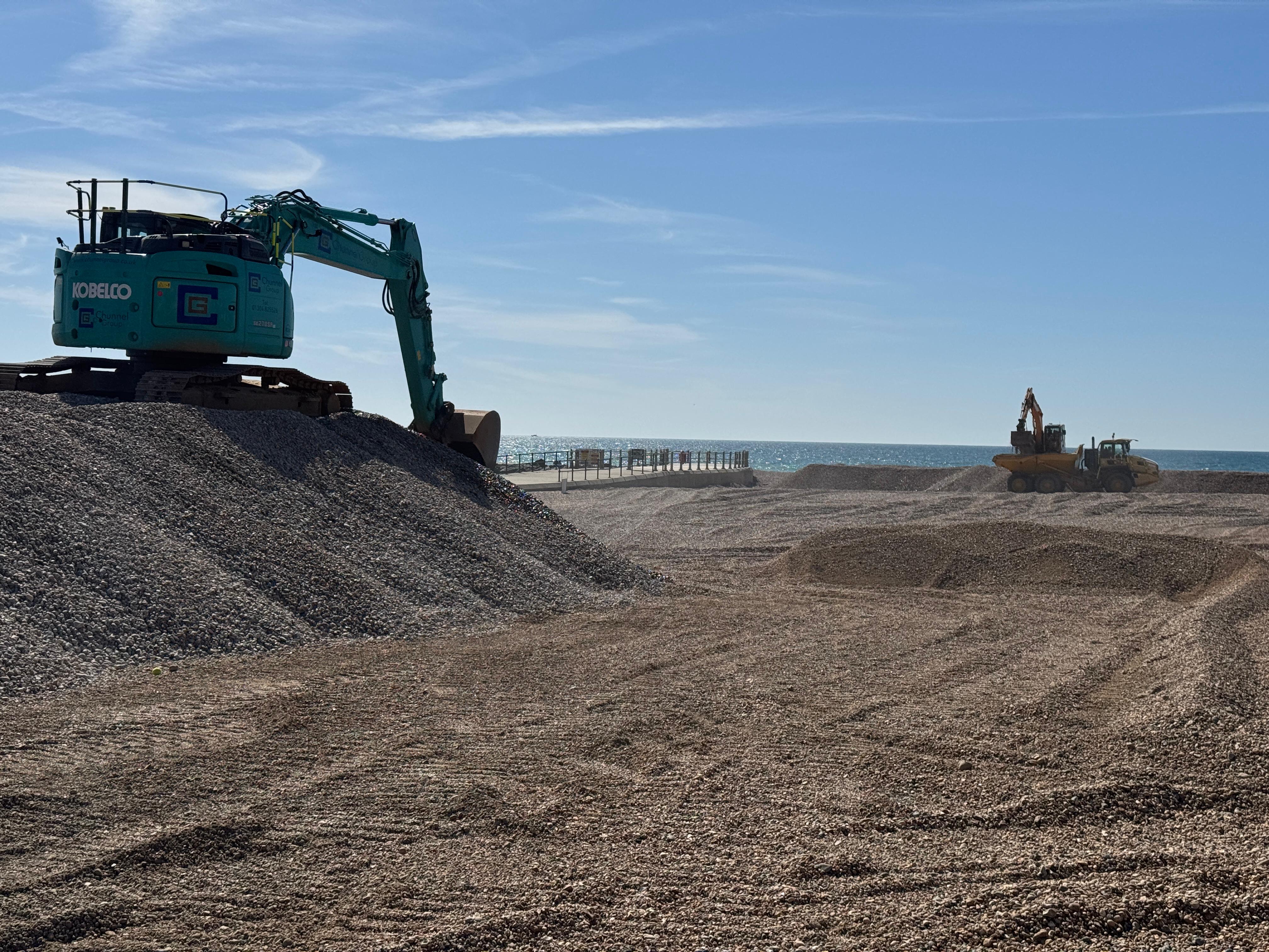 Using machinery to stockpile shingle in Hastings