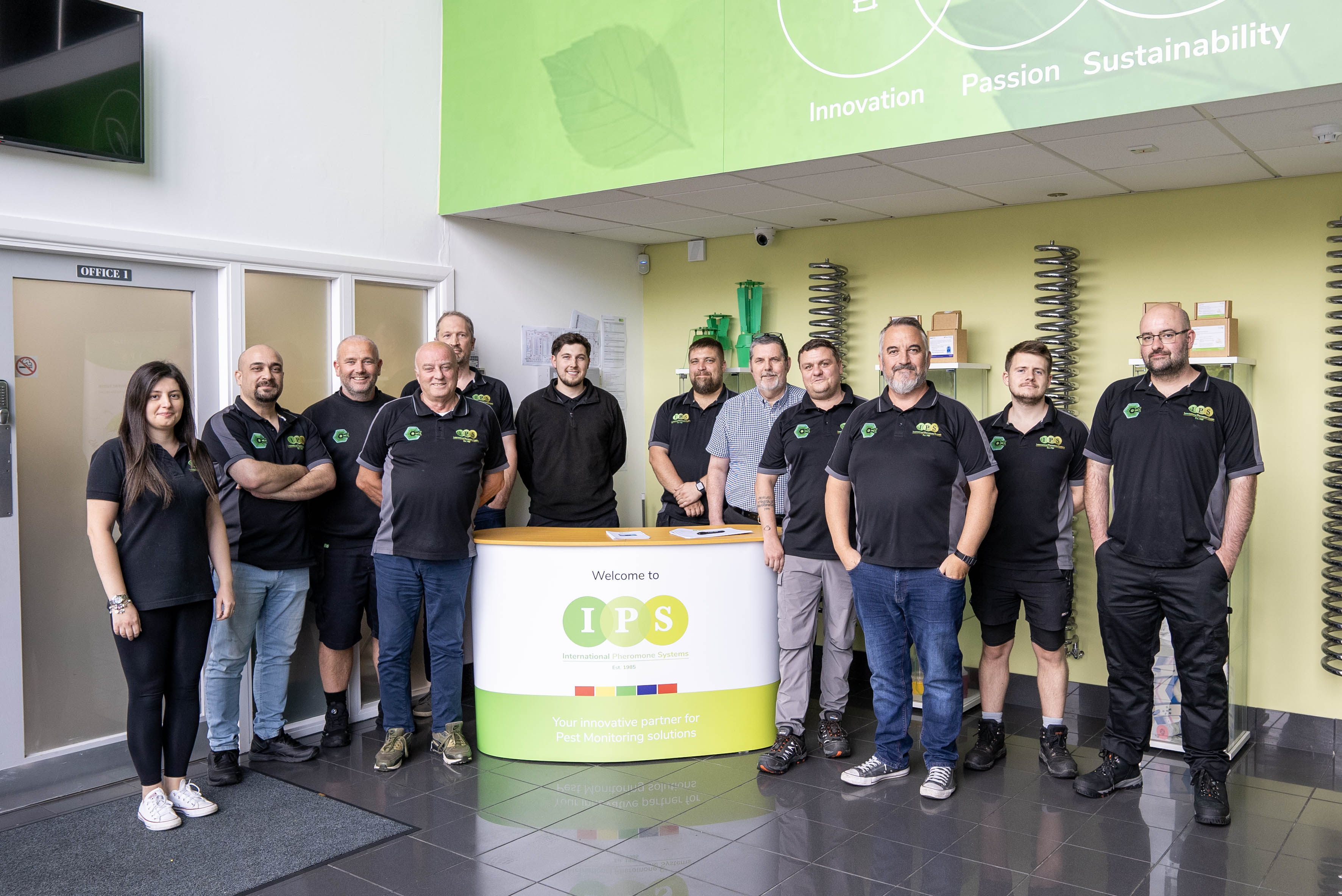 Picture of staff standing around a desk with IPS sign