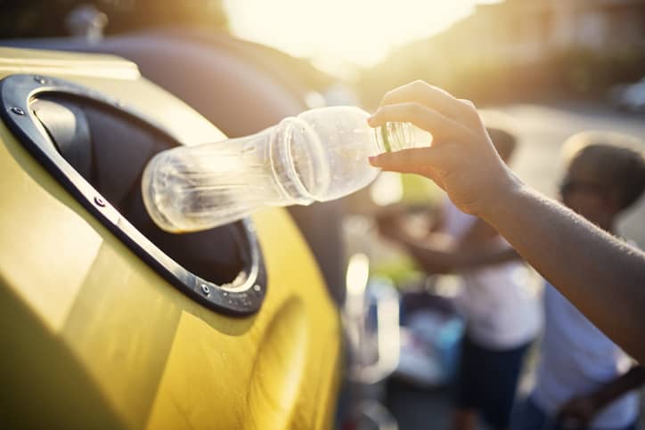 Person recycling a plastic bottle