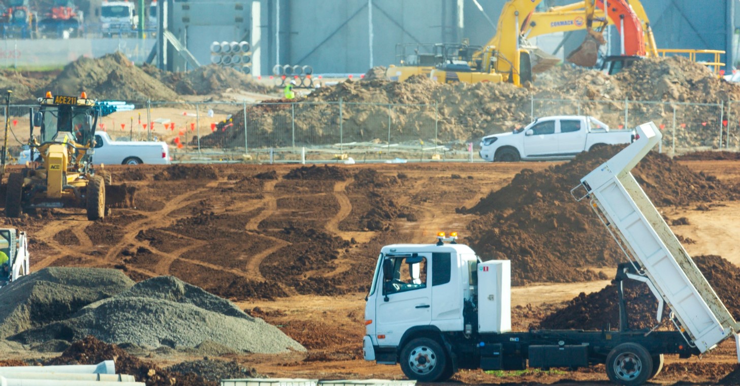 Image of construction of a site, with construction vehicles