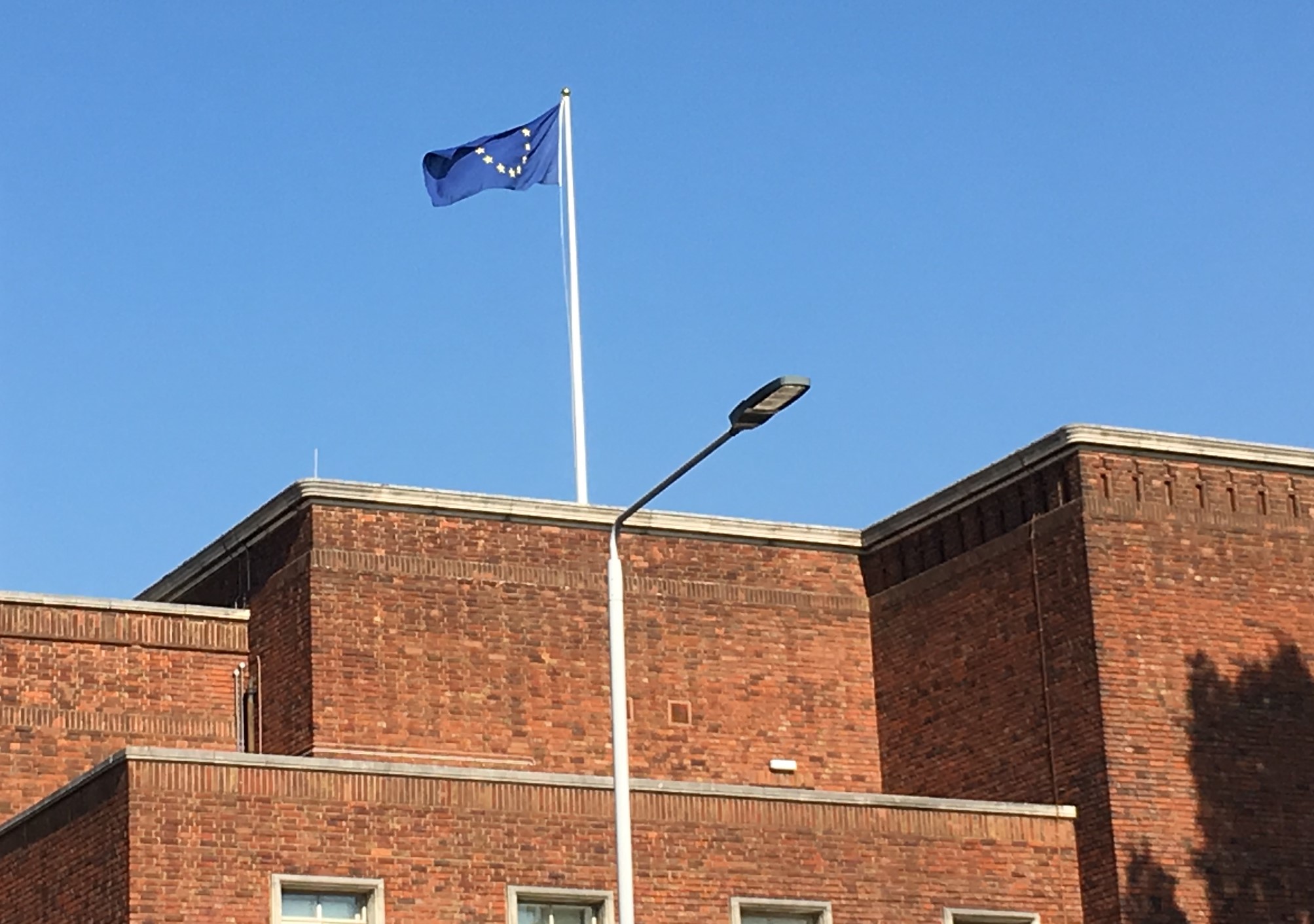 The EU flag flying over H&F Town Hall against a blue sky