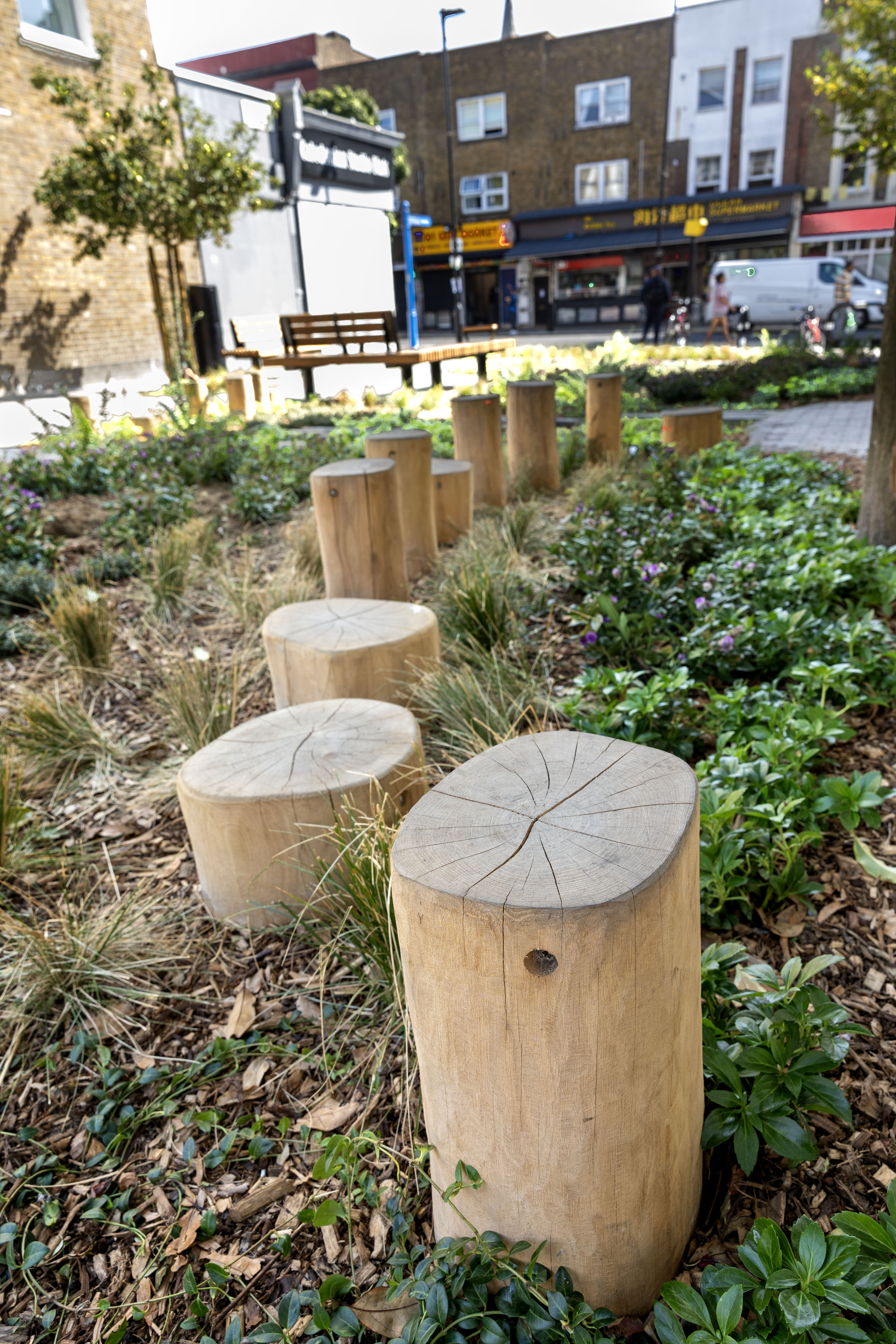 image showing informal play features in a public space, in the form of wooden stakes / posts 