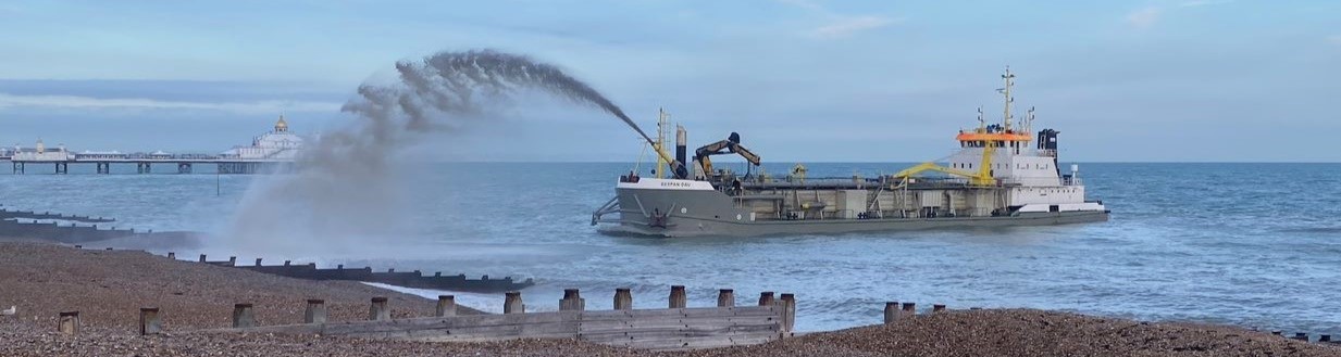 The 'Spspan Dau' dredger spraying shingle onto Eastbourne beach