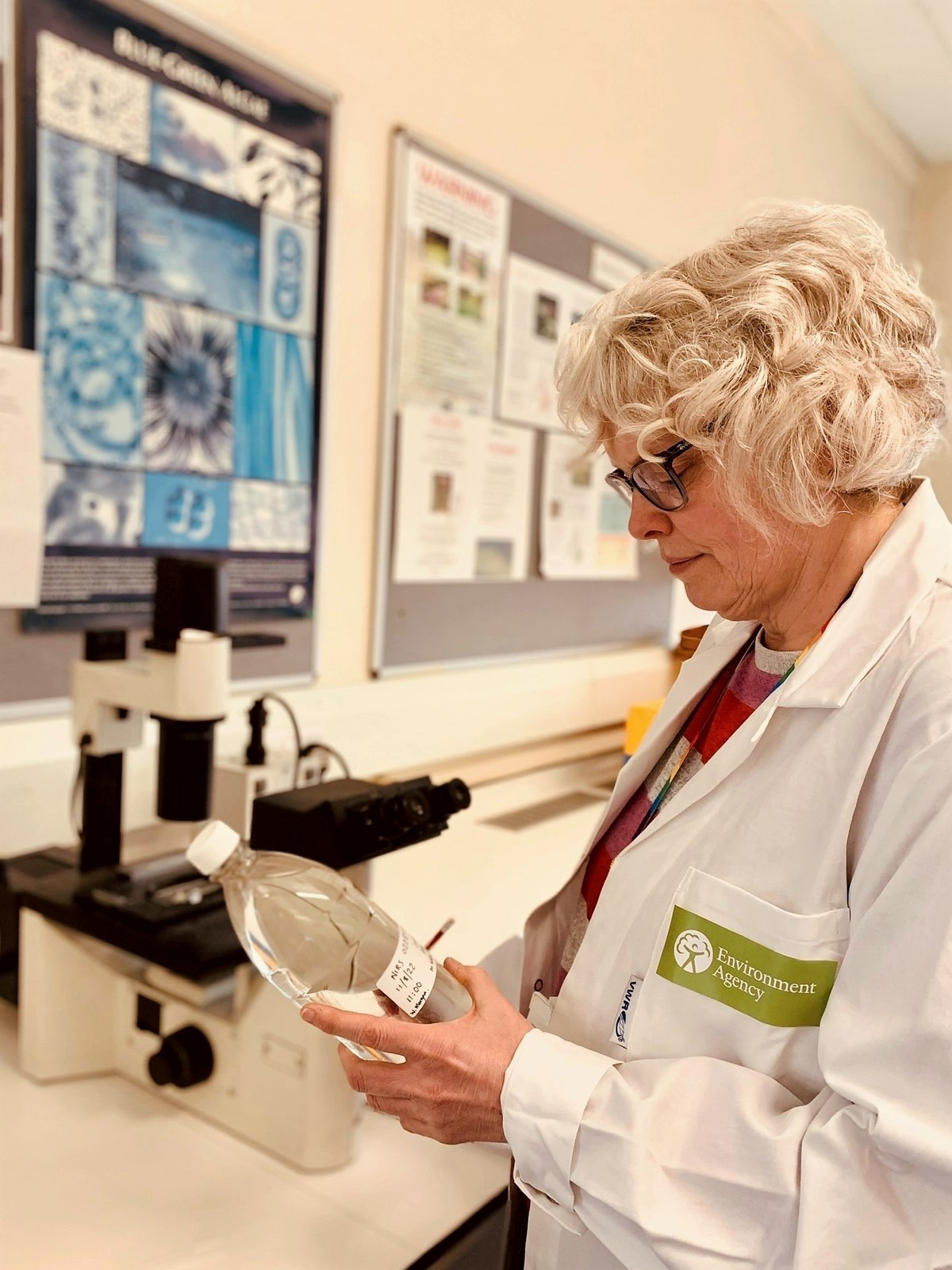 A photo of a scientist from the Environment Agency analysing a water sample in a laboratory
