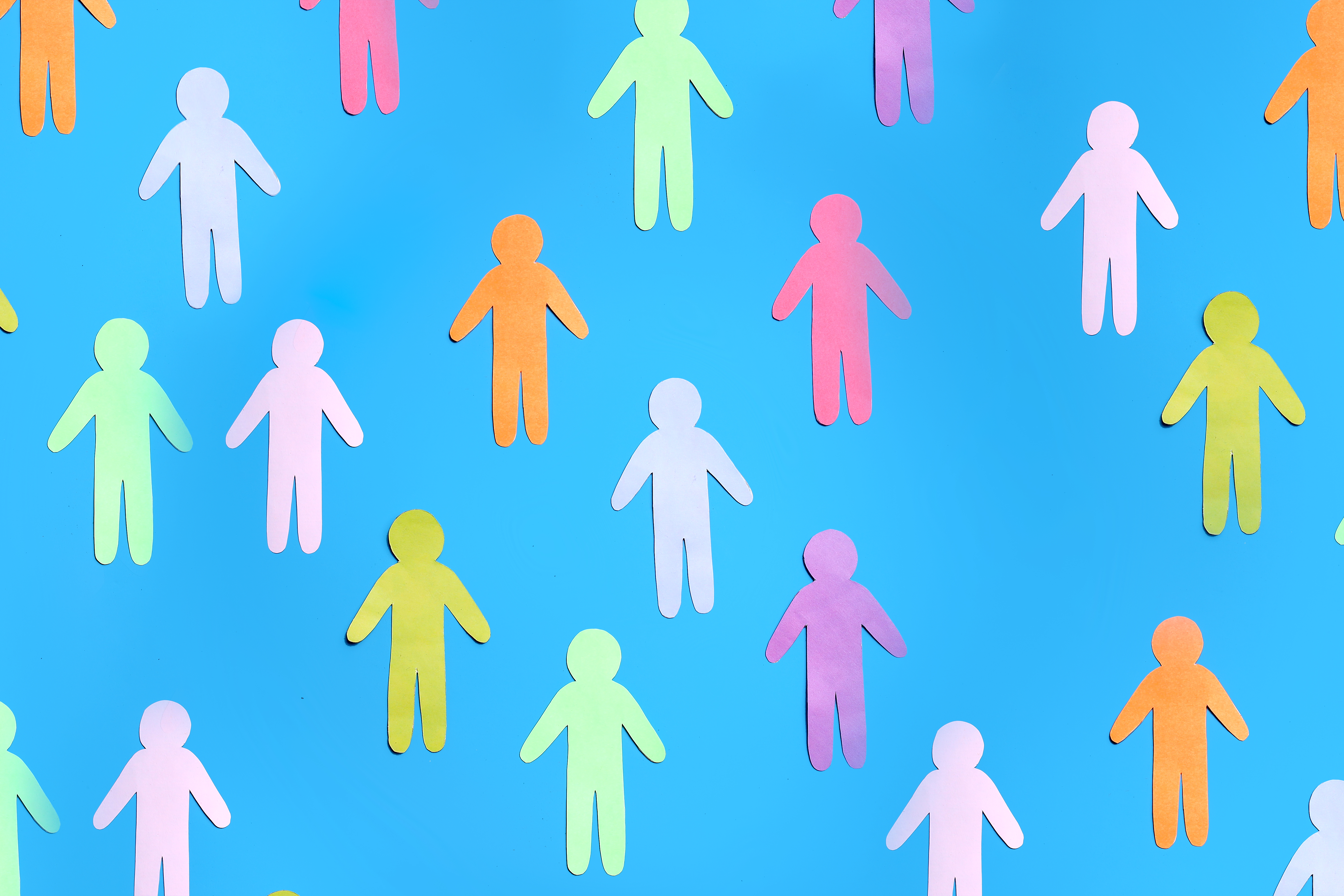 paper human figures in multiple colours on a blue background