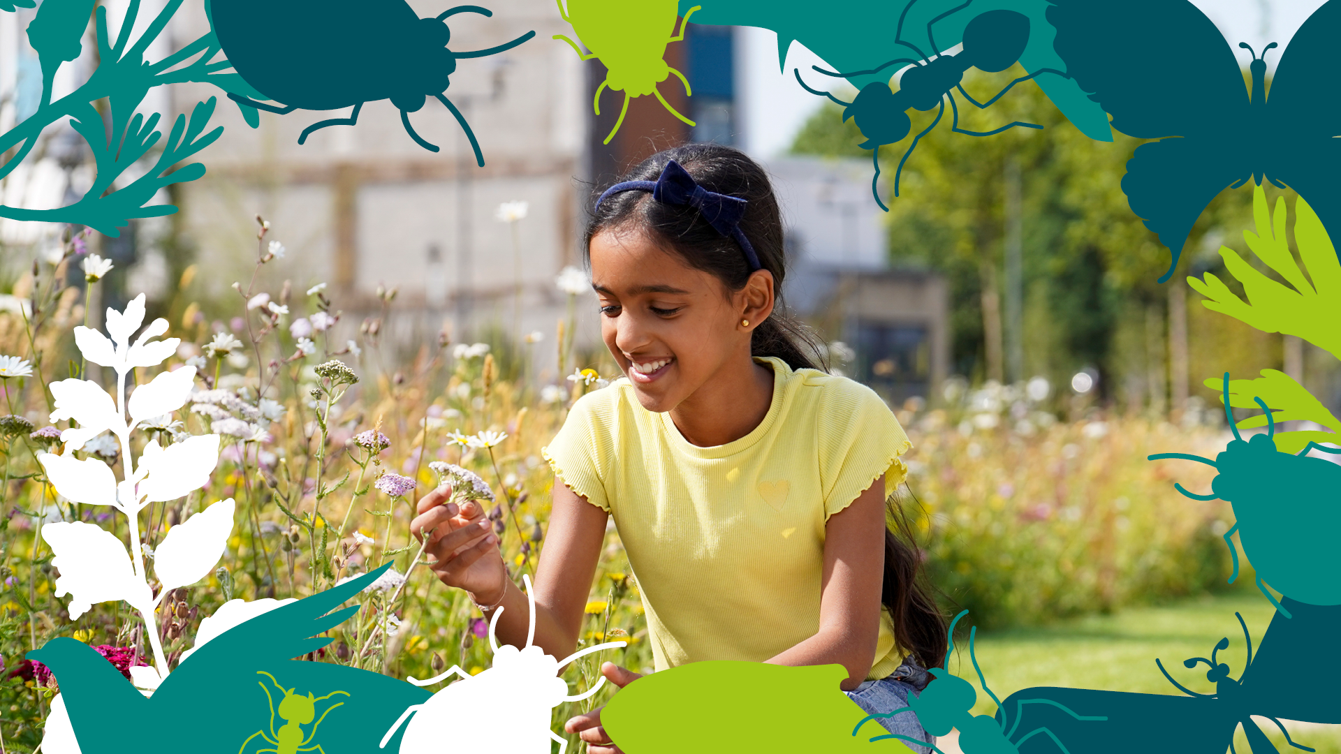 A young girl outside enjoying looking at flowers in the sunshine.