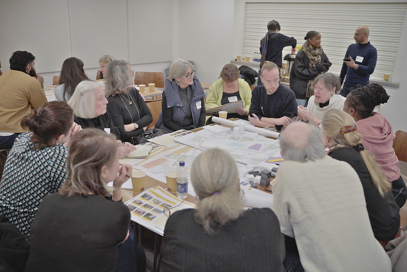 A group of people discussing around a table