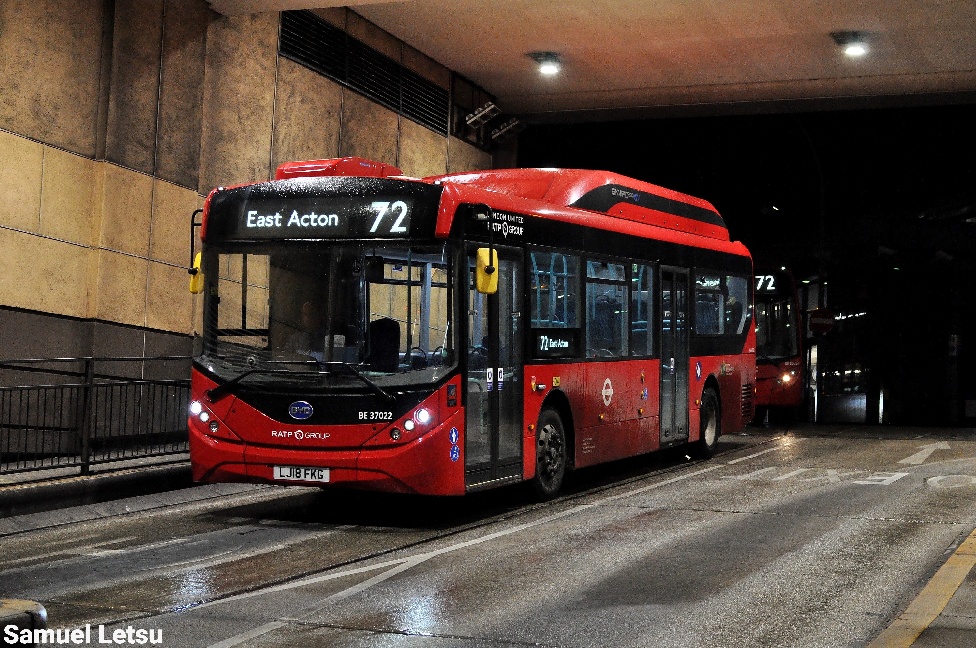 Nighttime view of London bus route 72 to East Acton driving through a tunnel