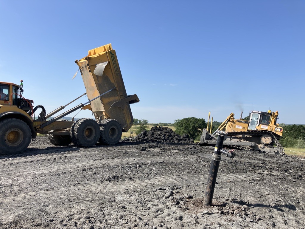 Heavy plant working to complete capping work at lower compton landfill site, a gas well can be seen in the picture