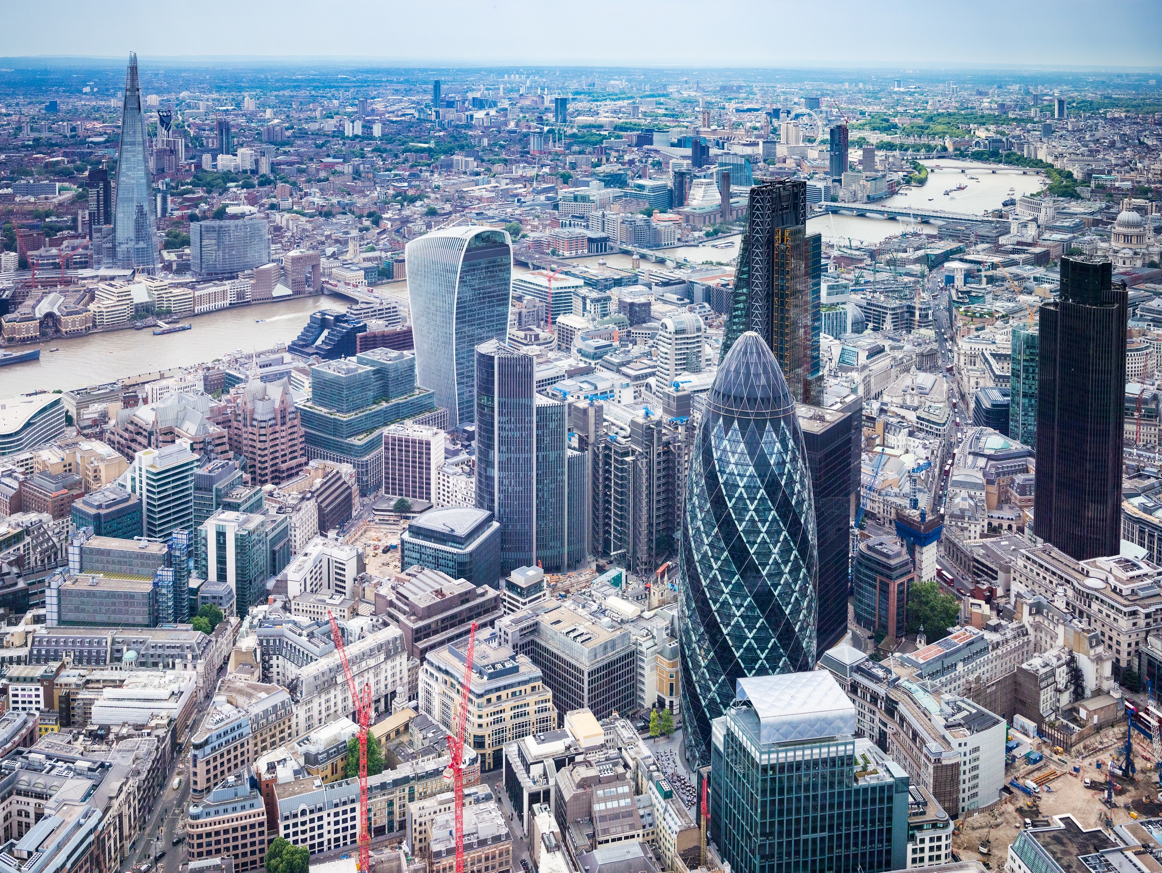 Aerial view of central London showing the City skyline, including the Gherkin, the Walkie Talkie and the River Thames