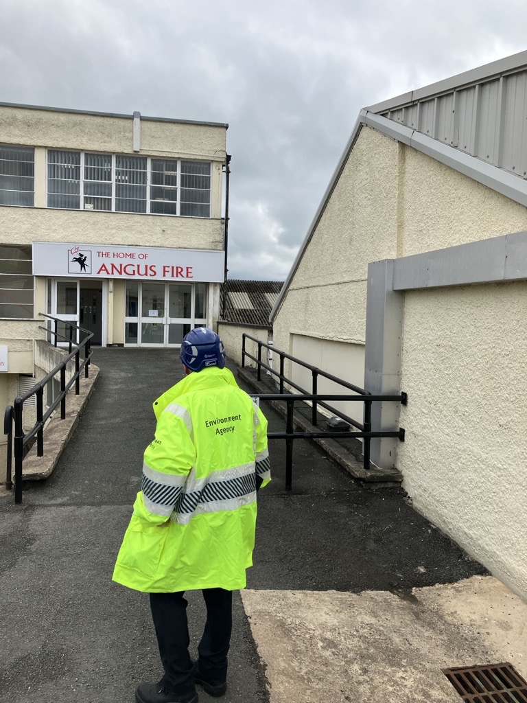 EA Officer outside Angus Fire head office, wearing EA branded High Viz jacket