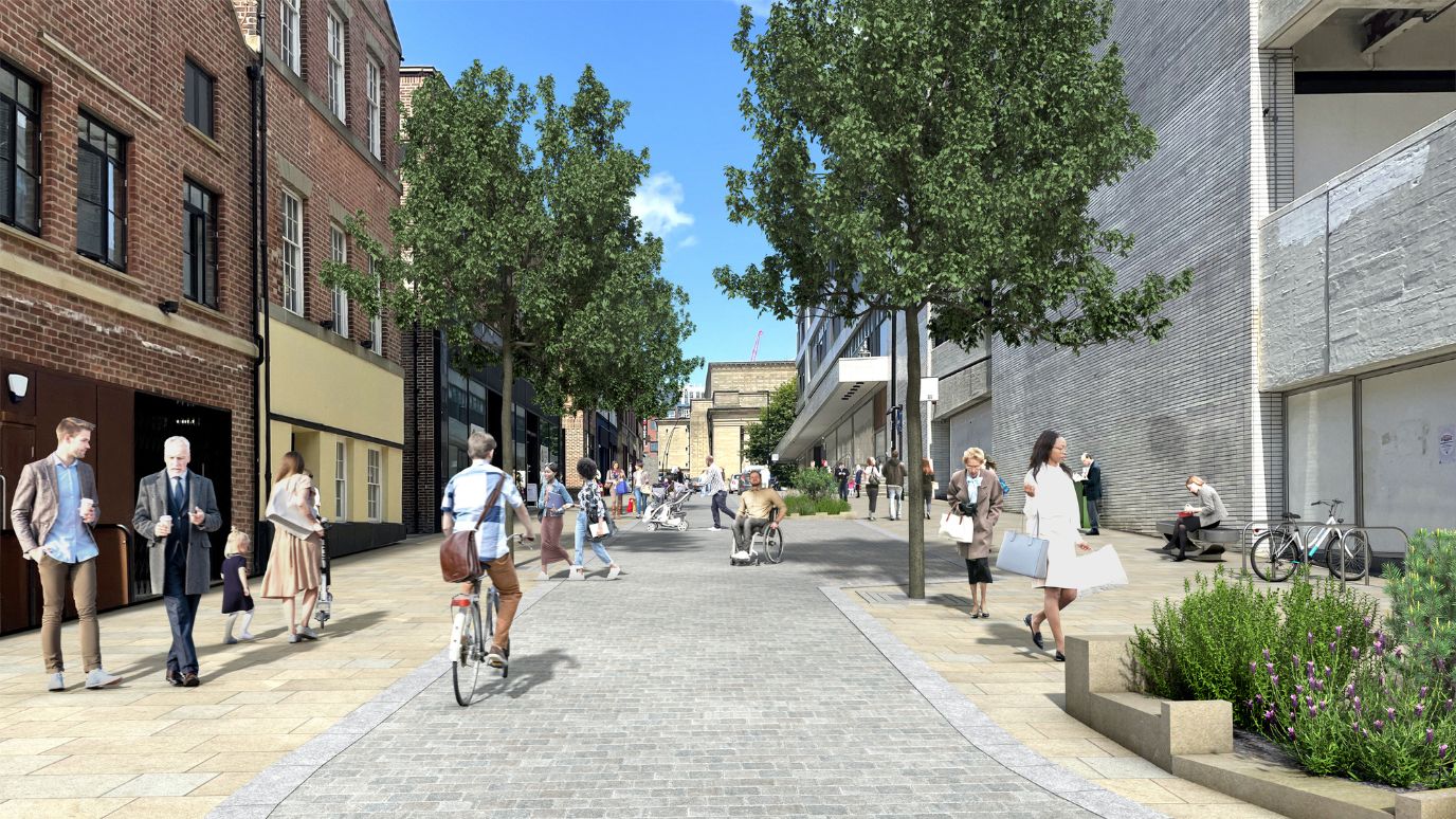 An artist impression of a busy city centre street with people walking, wheeling and cycling. Buildings stand on either side with trees and planing, blue sky can be seen in the background