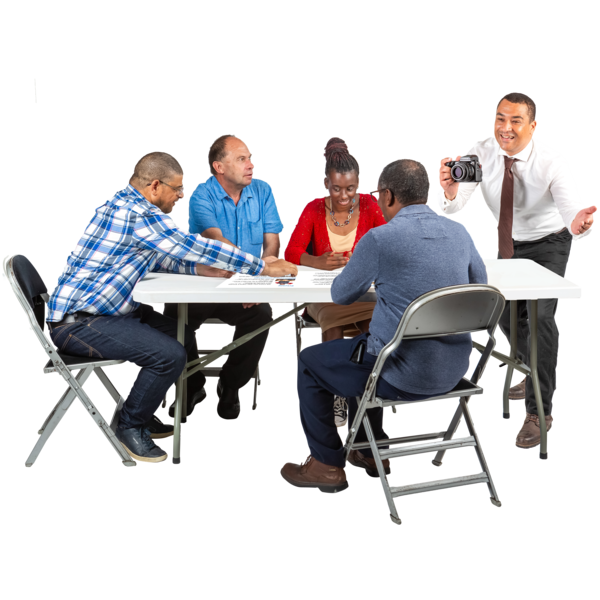 A group of adults sat around a table talking and planning