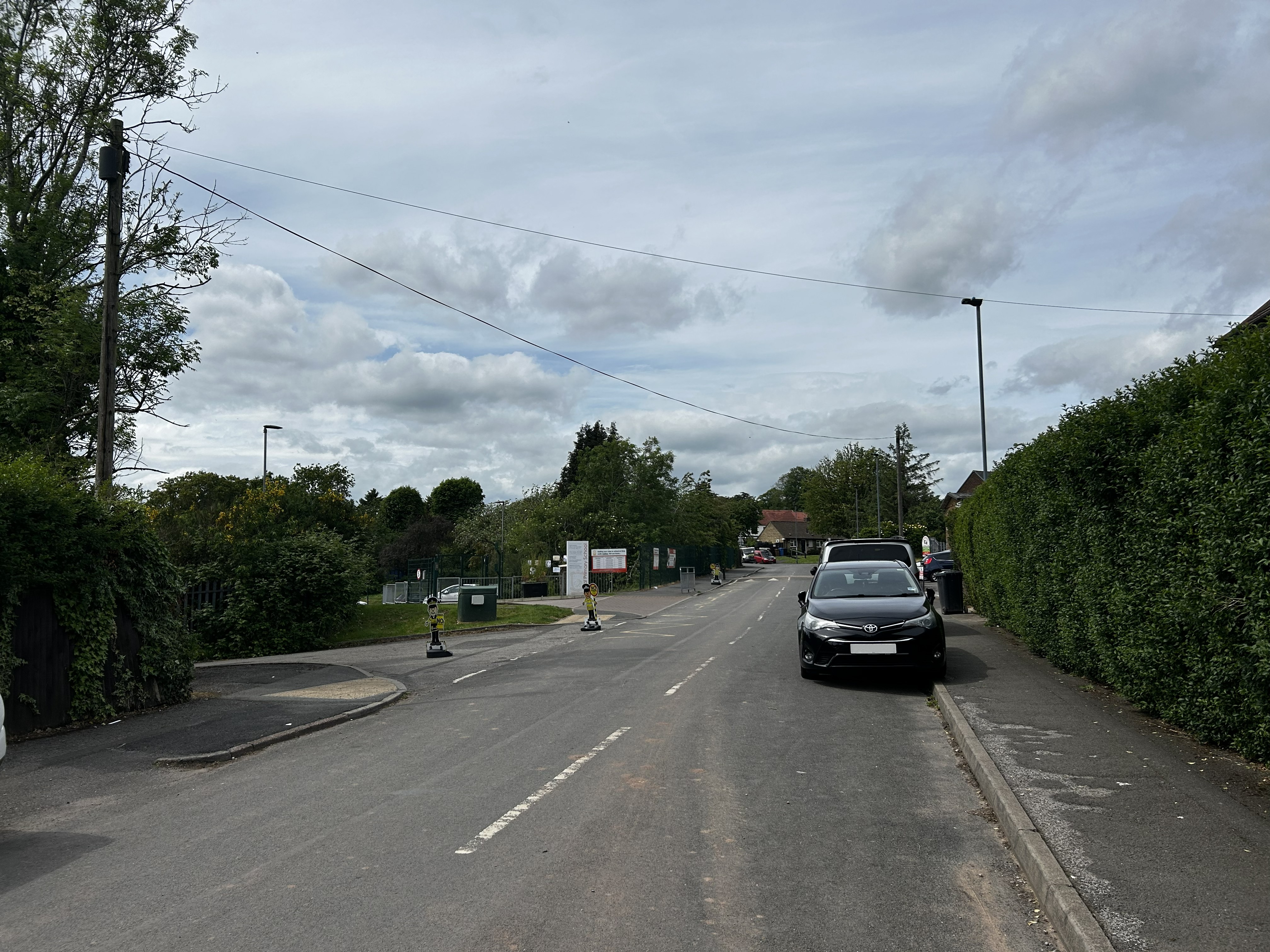 Photograph of cars parked on the kerb opposite Akaal Primary SchoolSchool