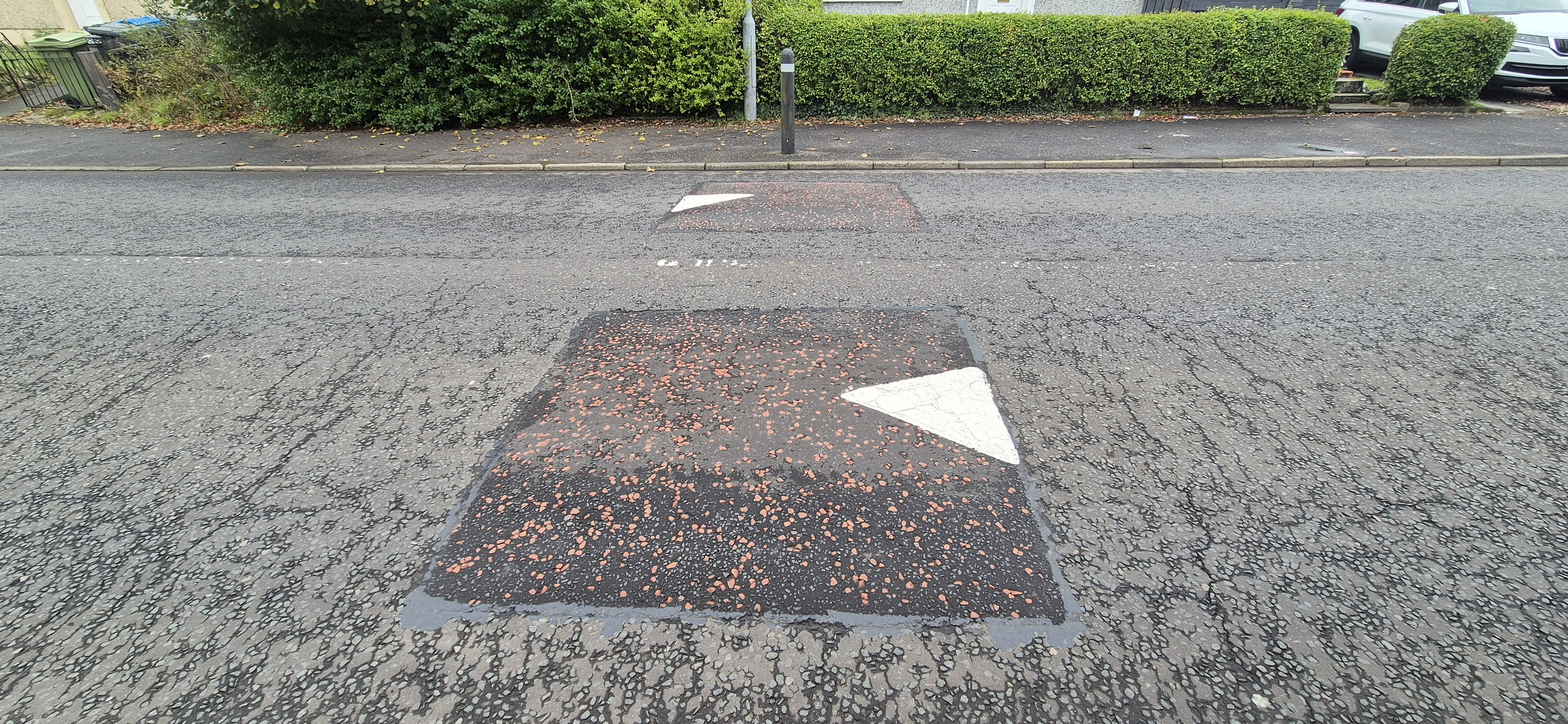 Photo showing new speed cushions on a road.