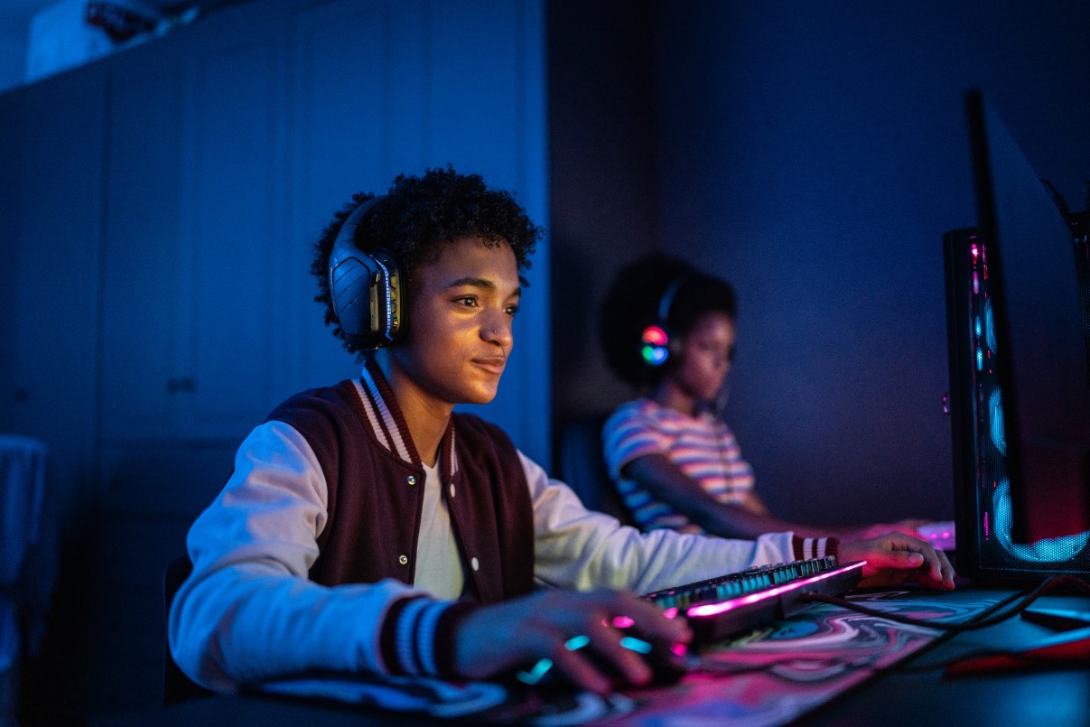 Teenage boy playing on the computer at home