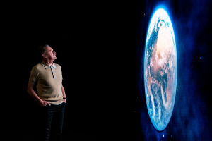 Image of person looking at world on a screen