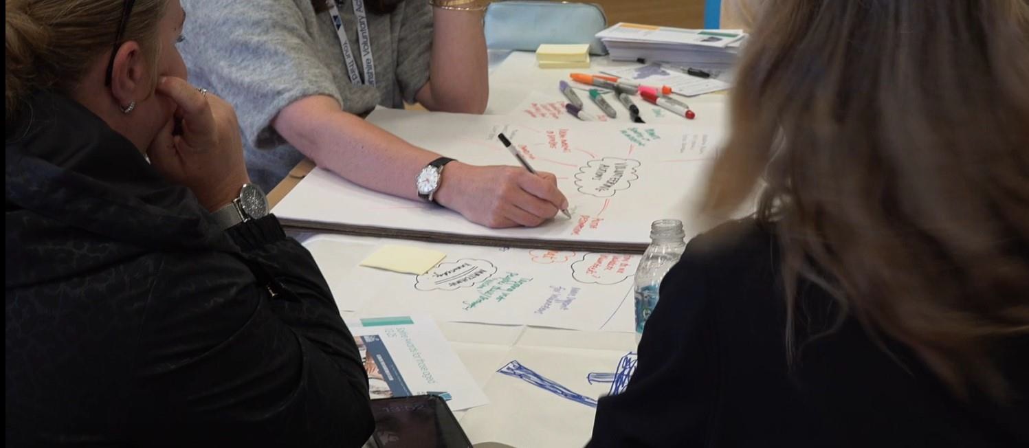 Image of person writing on flipchart