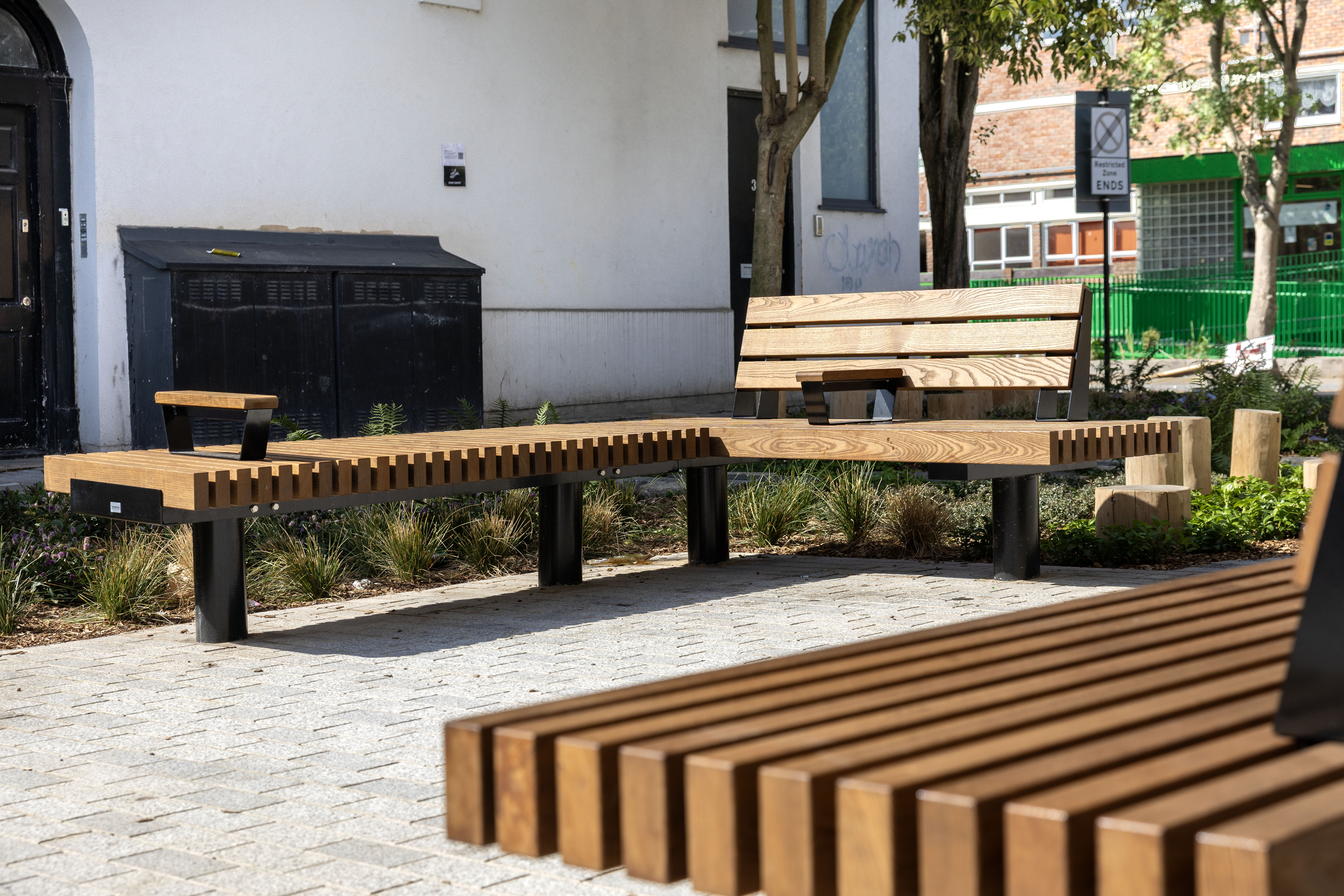 image showing a public space with benches and planting