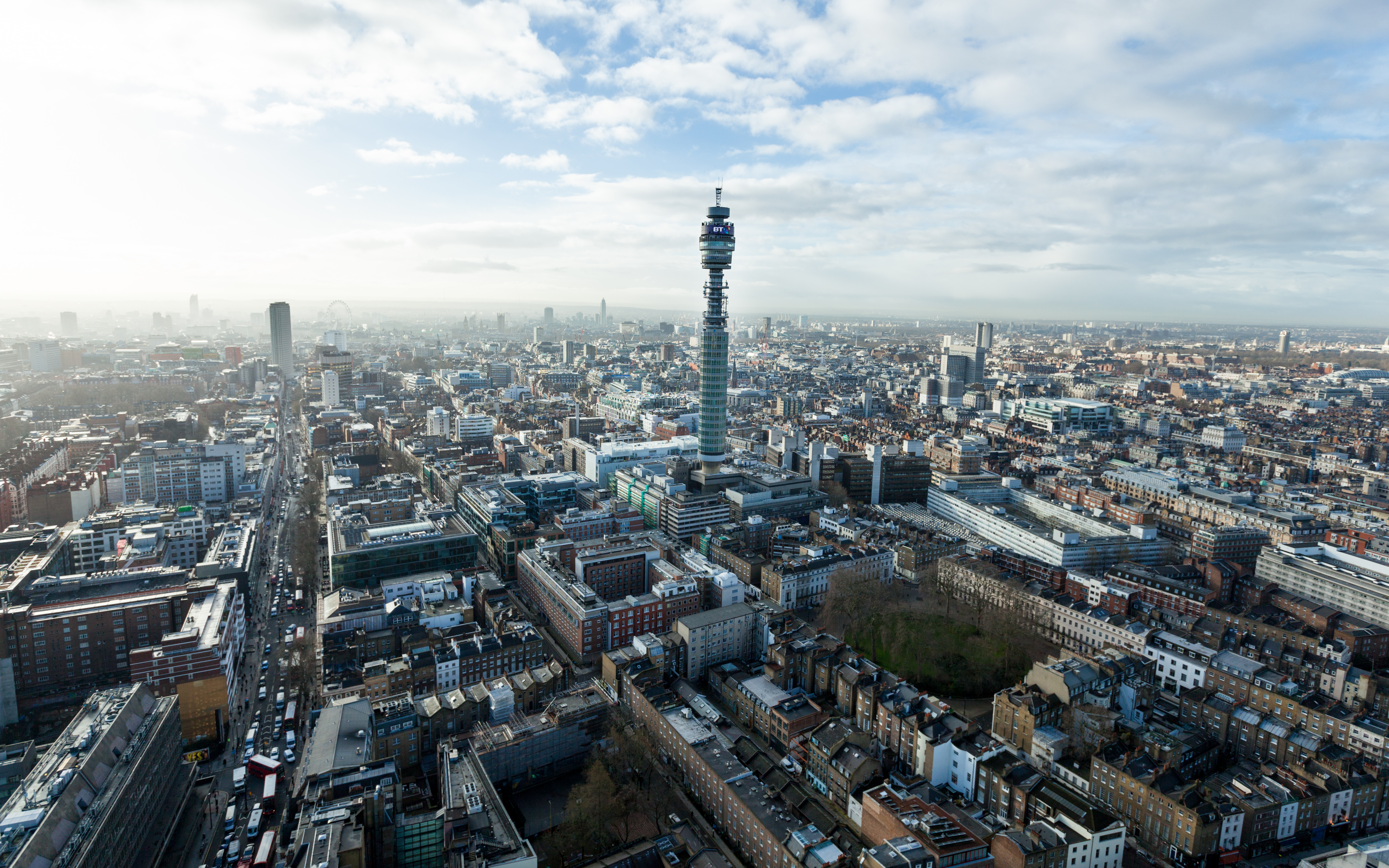 Aerial view of central London with the BT Tower rising above dense urban streets and buildings 