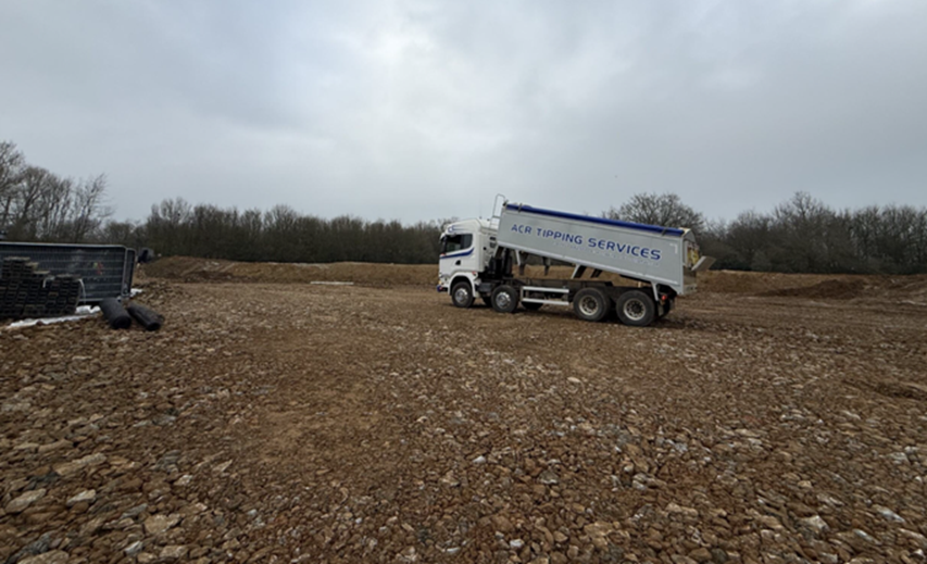 photo showing a dumper truck delivering aggregate to site