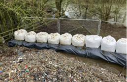 image from April 2026 showing line of jumbo sandbags