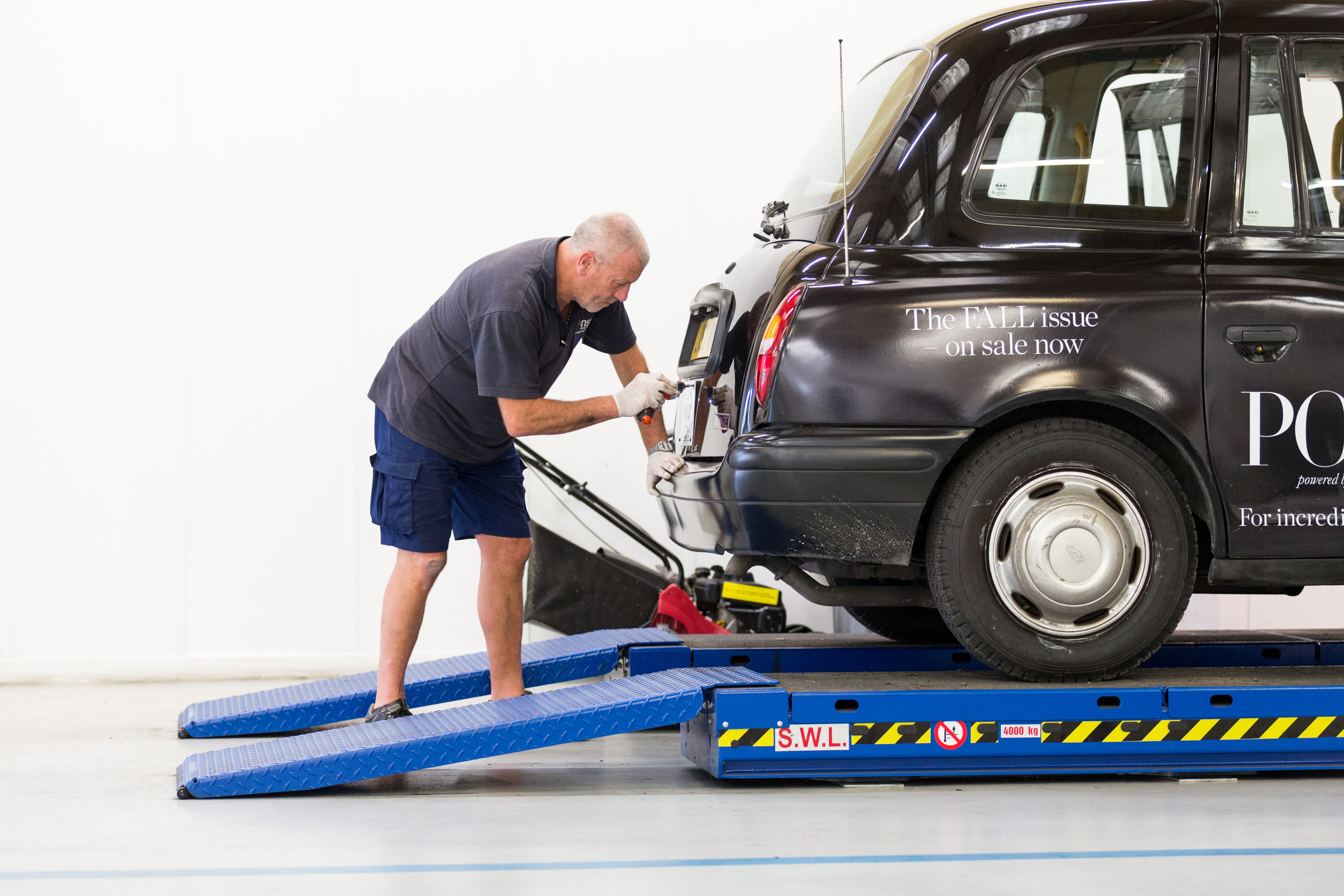 Picture of a man working on a taxi