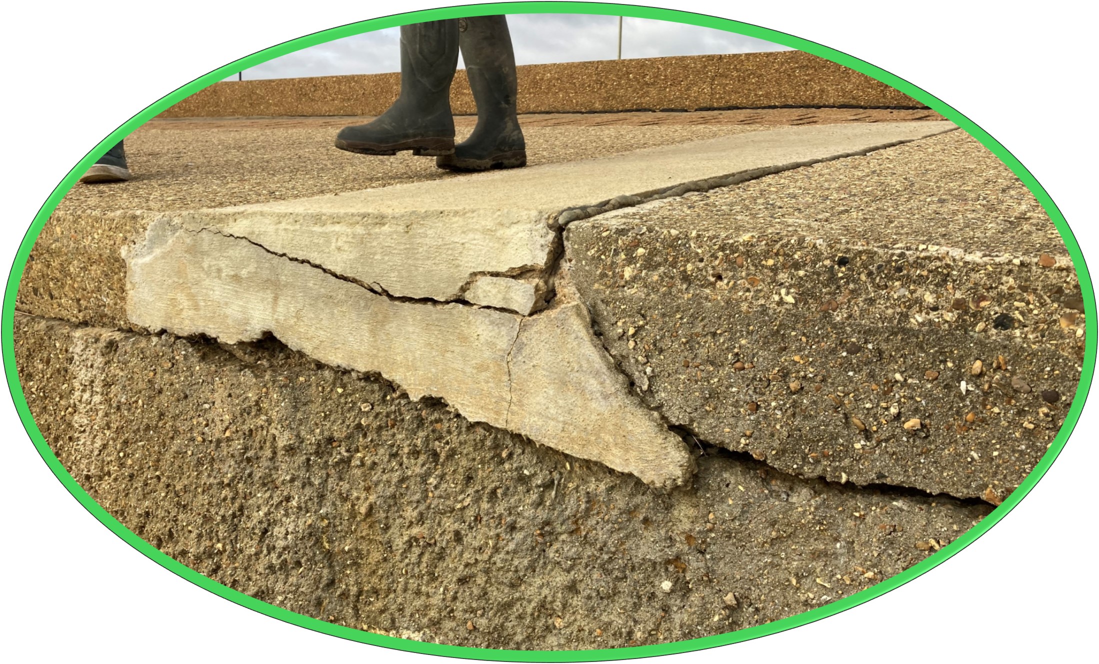 Image shows the condition of the sea wall with large cracks.