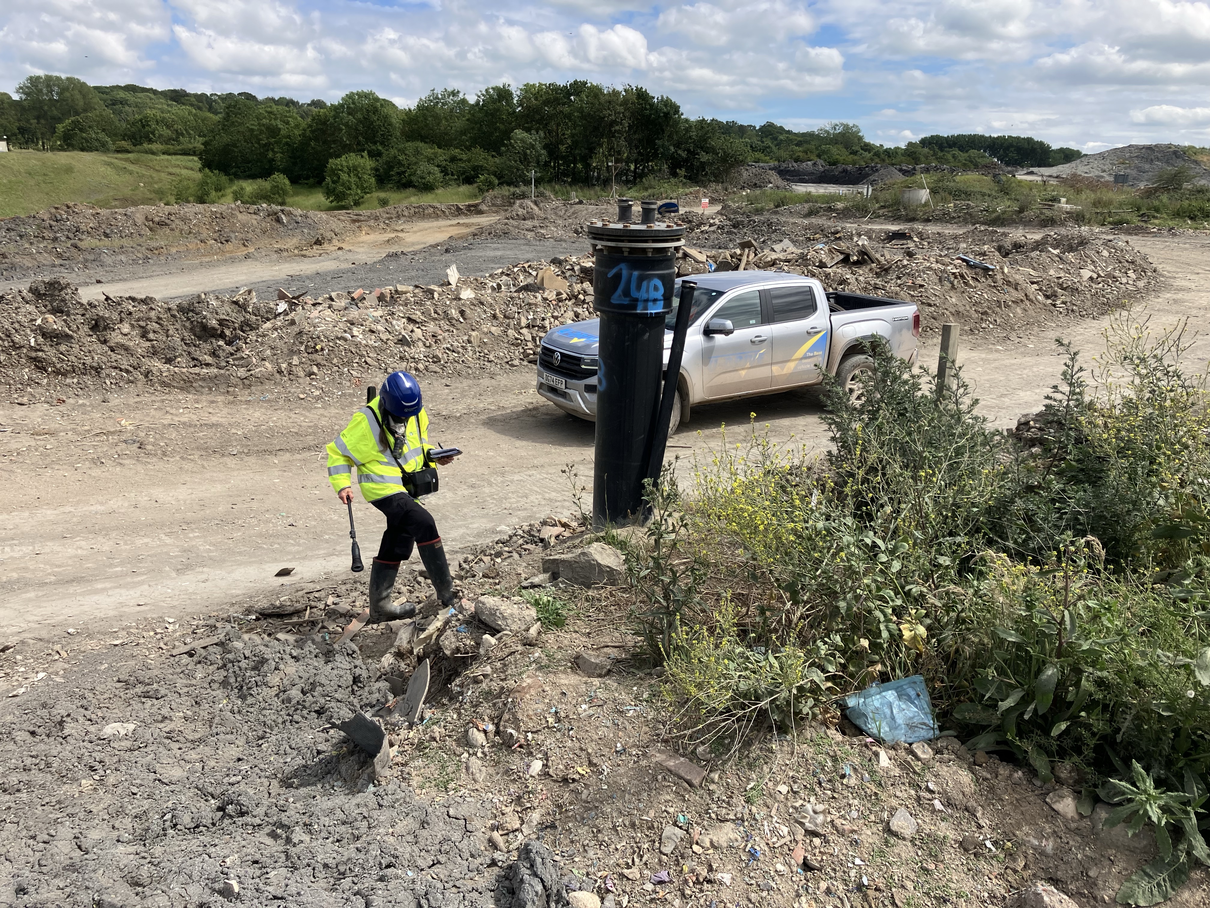 An Environment Agency staff member uses a device to monitor for gas at the Lower Compton landfill site