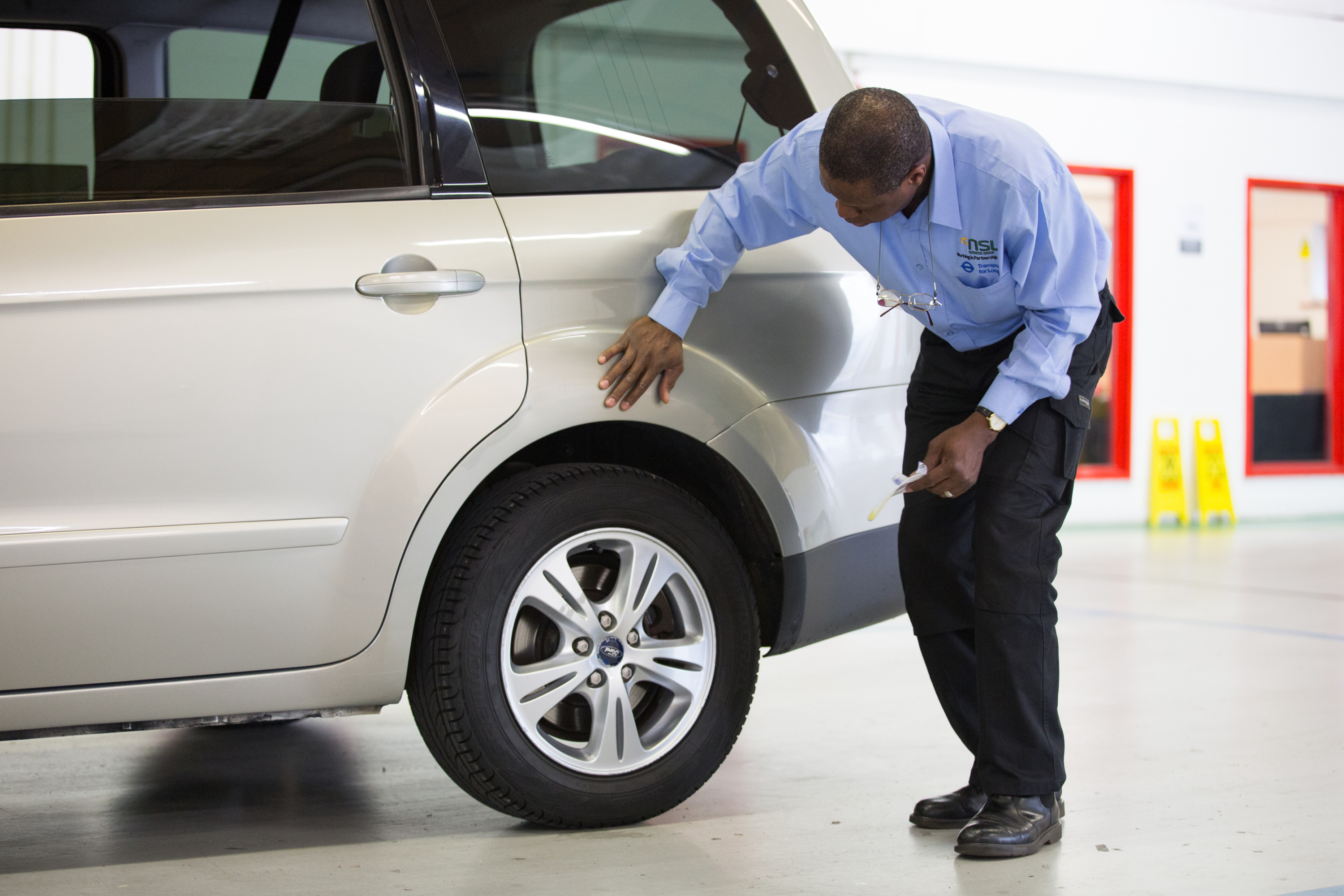 Picture of a man inspecting a vehicle