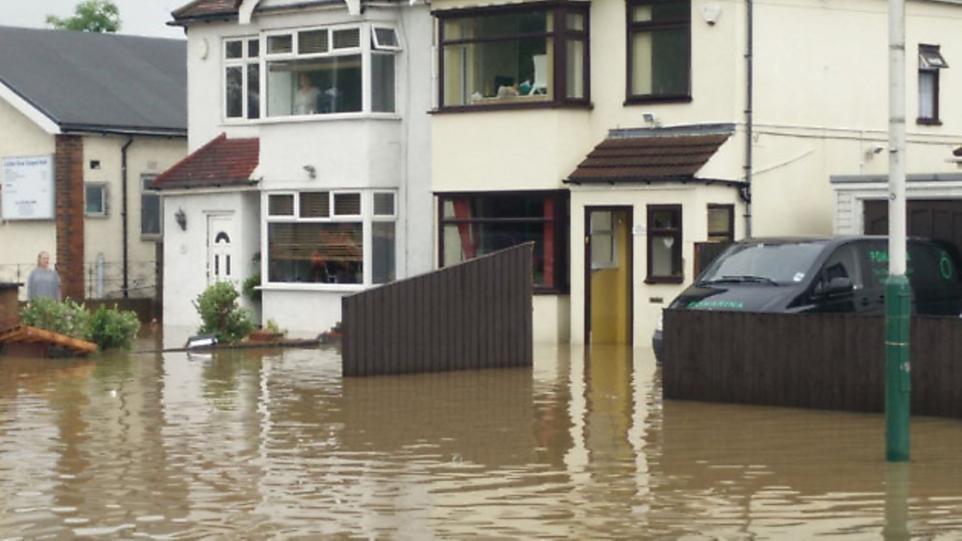 A picture showing flood water submerged Collier Row with flood water reaching to the front doors of homes.