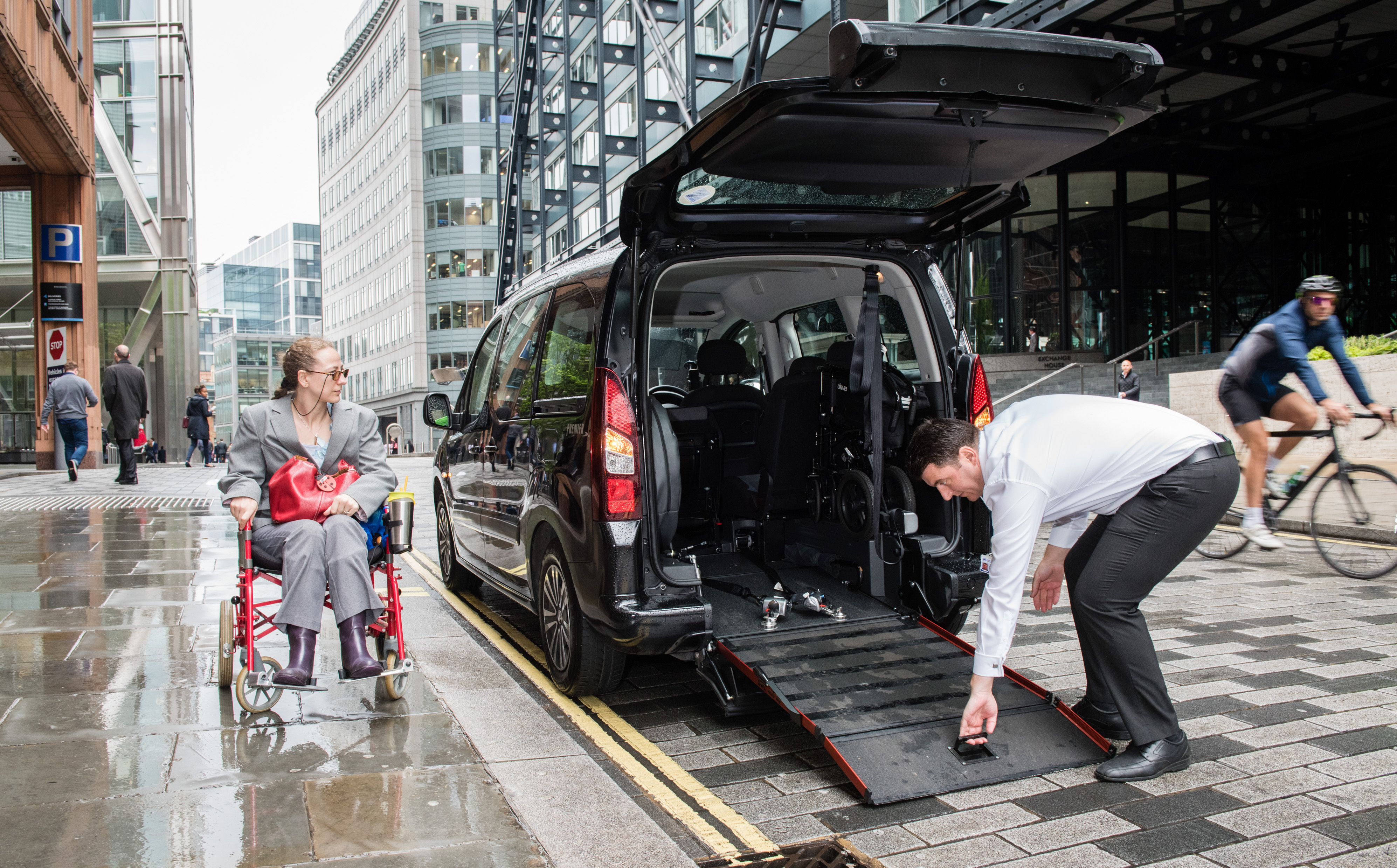 Accessible taxi with wheelchair ramp deployed at the kerbside