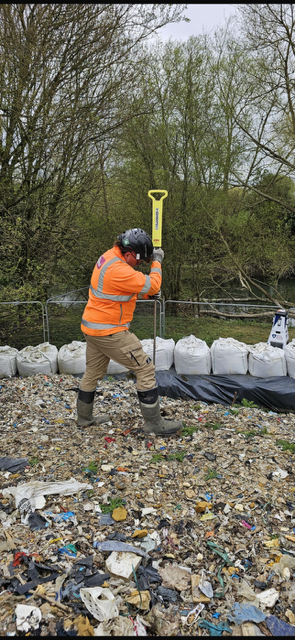 image showing worker installing thermal probe into the waste